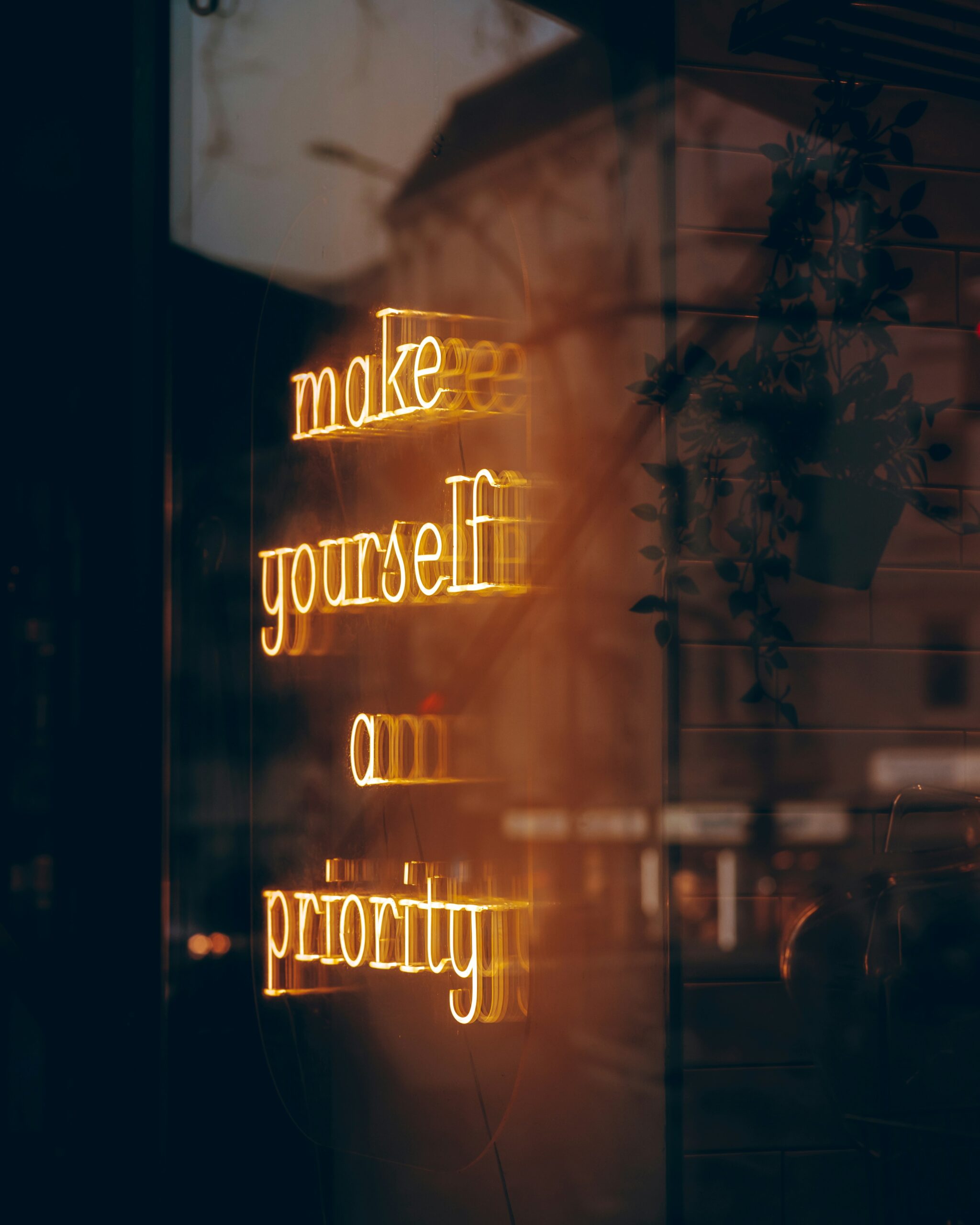 make yourself a priority neon sign in dark saying: make yourself a priority